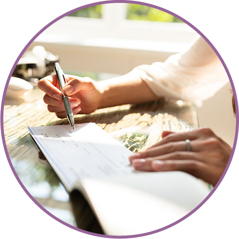 a woman writing a cheque